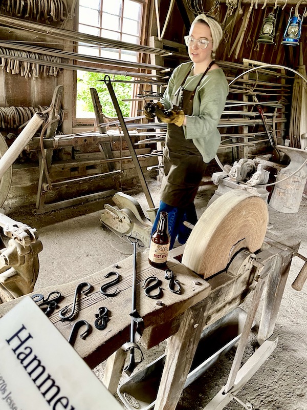 Woman forming a wrought iron bottle opener at the Herbert Hoover National Historic Site Iowa
