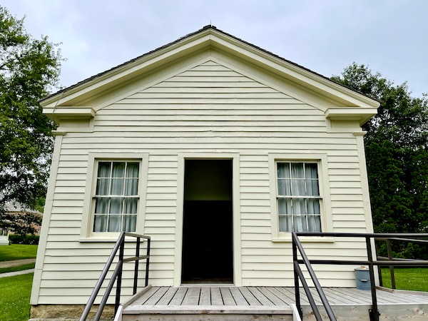 Pale green single room building with steps and landing at the Herbert Hoover National Historic Site Iowa