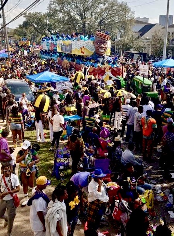 A crowd of people along the parade route for Mardi Gras 2023 New Orleans