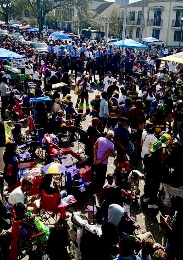 Crowd of people along a parade route during Mardi Gras 2023 New Orleans