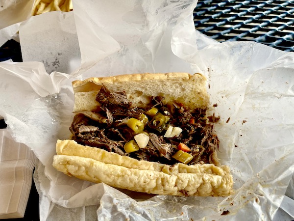 A roast beef sandwich with pickled vegetables on a sub roll eaten on Our Driving Tour of Chicago IL