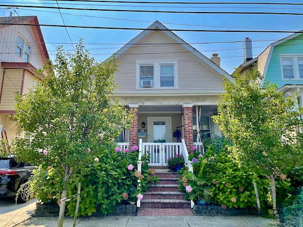 Single home with front porch and white staircase. Our summer home in NE America