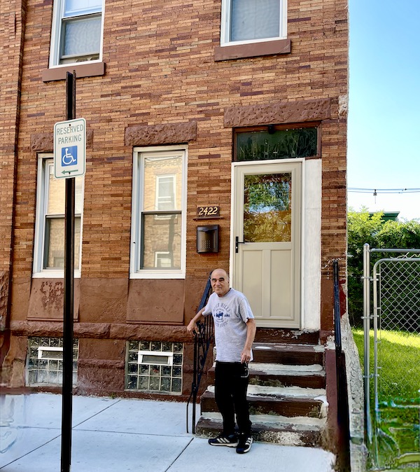 Red brick row house with steps and Steve standing in front, part of All Our Houses in Northeastern America