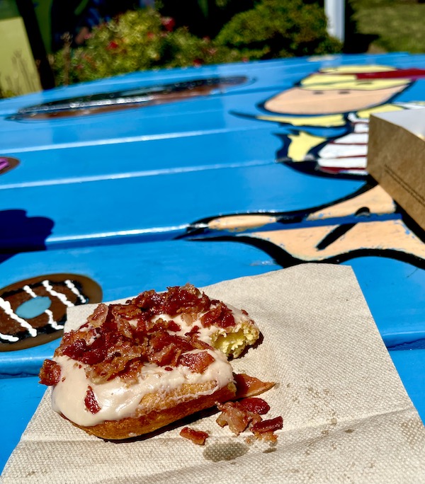 Bacon topped donut on a tan paper napkin at Duck Donuts Mechanicsburg PA