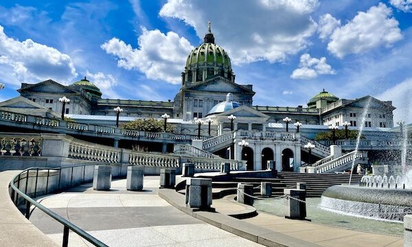 View of the Pennsylvania State Capitol Harrisburg showing several colored domes on the roof.