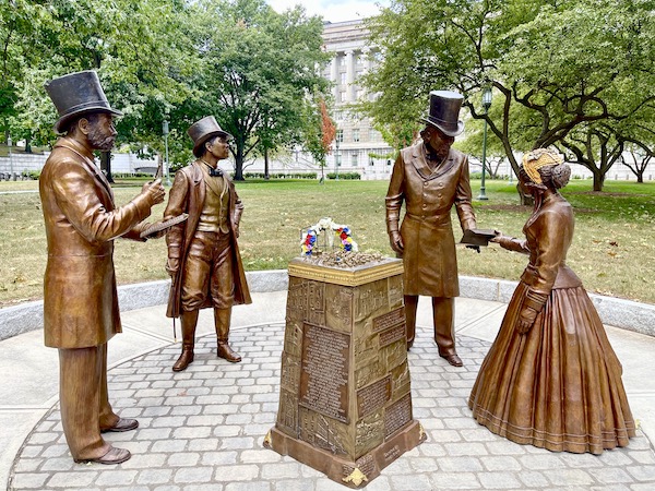 Bronze statues of 4 Pennsylvania orators and a bronze monument in center.