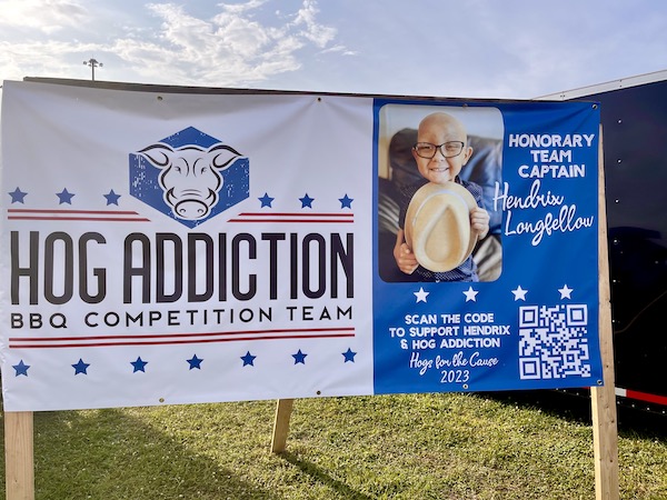 Large banner featuring a pediatric cancer patient and QR code to donate to Hogs For The Cause
