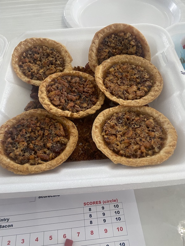 Styrofoam clamshell holding 6 mini pecan pies at Hogs For The Cause NOLA