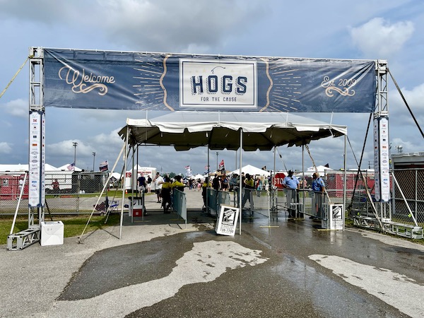 Banner for Hogs For The Cause NOLA at the entrance to the event