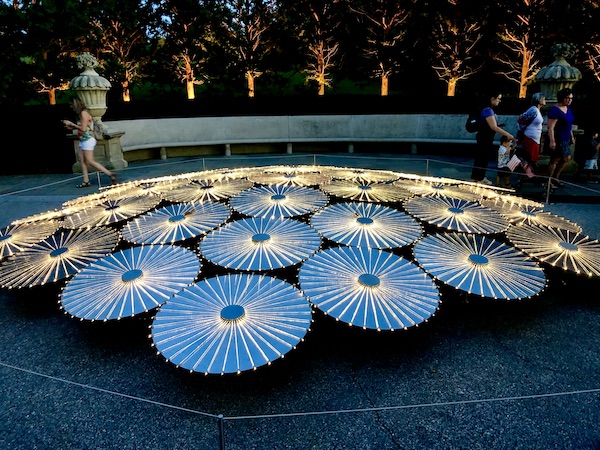 Bruce Munro lights create a cluster of Japanese umbrellas at The nighttime spectacle Light: Installations by Bruce Munro opens June 30 at Longwood Gardens. Created by English/Australian artist Bruce Munro, Light features eight installations, spanning indoors and outdoors. Highlights include the luminous Field of Light featuring 18,000 illuminated bulbs stretching across the landscape, a flamboyance of 1,000 flamingoes wading near the Chimes Tower, and C-scales, a shimmering canvas of 8,960 CDs in the Exhibition Hall that reflect colorful projections inspired by Longwood’s water gardens.