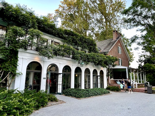 Brick house and theater extension with white arches at Longwood Gardens Kennett Square PA