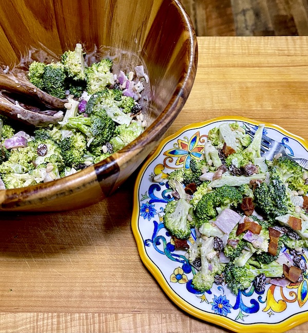 Wood salad bowl filled with broccoli salad with bacon and raisins from new book Available Now Tasting Alabama