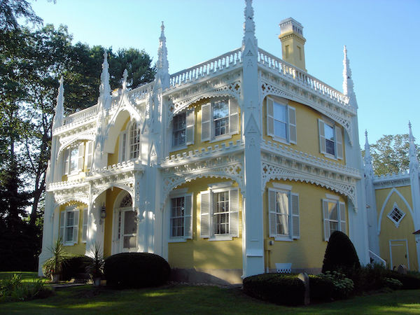 Yellow and white house known as the Wedding Cake House because of its ornate decoration.