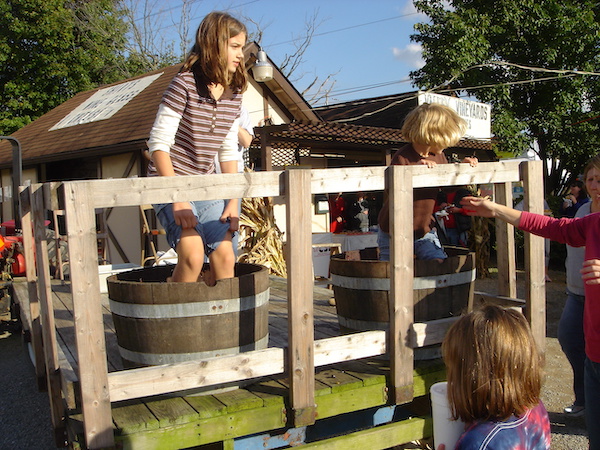 A girl stomping grapes in a barrel at a wine festival in Ohio
