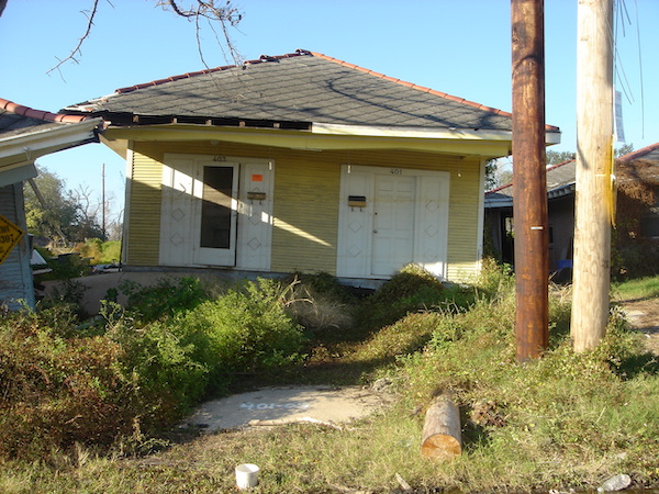 Yellow house washed up onto another house after hurricane Katrina came through New Orleans.