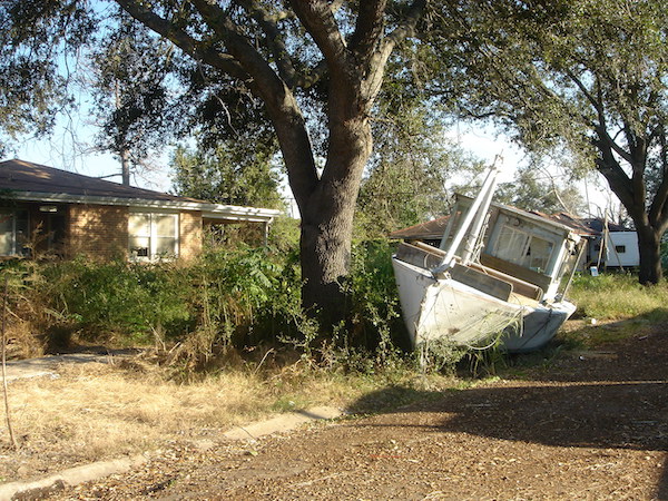 A boat sitting on the lawn after washing ashore in the hurricane.