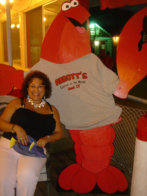 Me dressed in black sitting with a huge lobster replica that's wearing an Abbott's T-shirt, part of our Celebrating 3 Years as Full Time RVers!