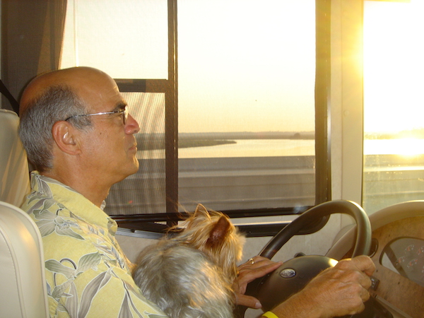 Steve behind the wheel of our first RV with yorkie on his lap.