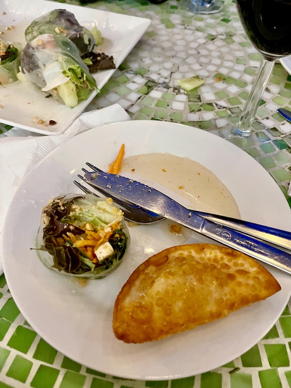 Plate topped with Spring Roll, Sweet Chili Sauce and Fried Wonton at a great place for Good Eats in the Big Easy