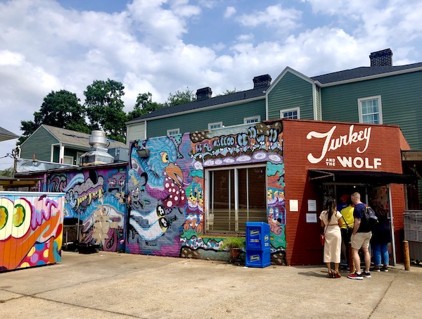 Mural covered building in the big easy that houses Turkey and the Wolf lunch restaurant.