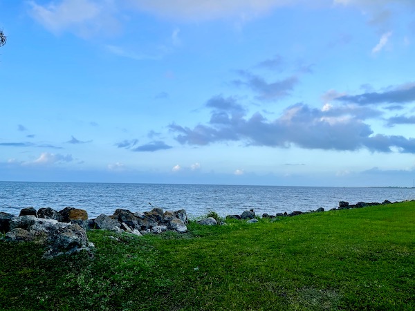 Huge lake with rock sea wall and grass by Lake Okeechobee Florida