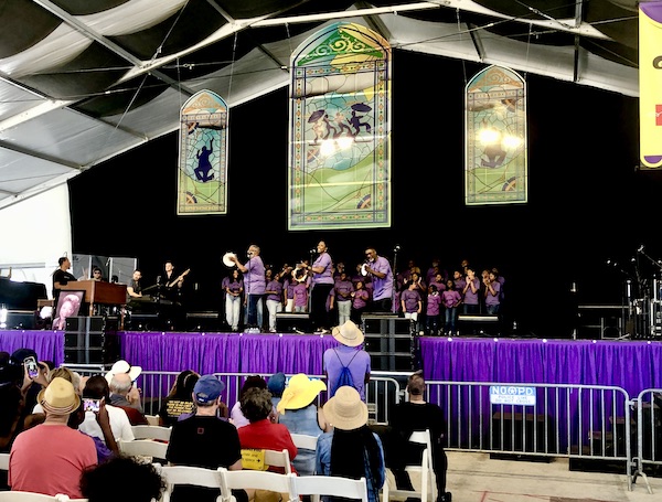 Listening to a gospel choir in the Gospel Tent at New Orleans Jazz and Heritage Festival