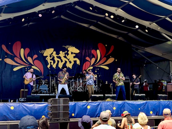 A stage with musicians performing at New Orleans Jazz and Heritage Festival