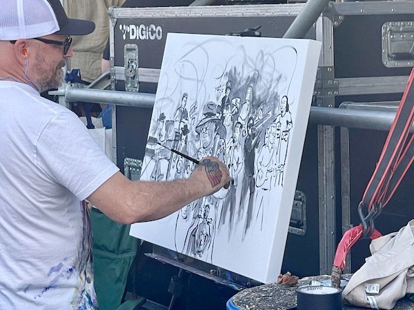 Artist continuing to work on his canvas