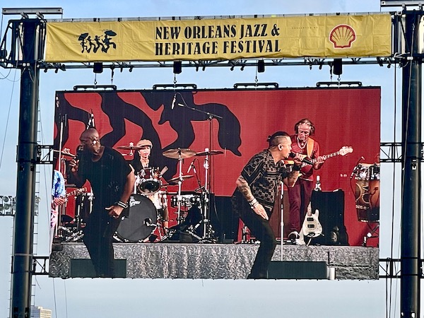 Singers and band perform on stage at New Orleans Jazz and Heritage Festival