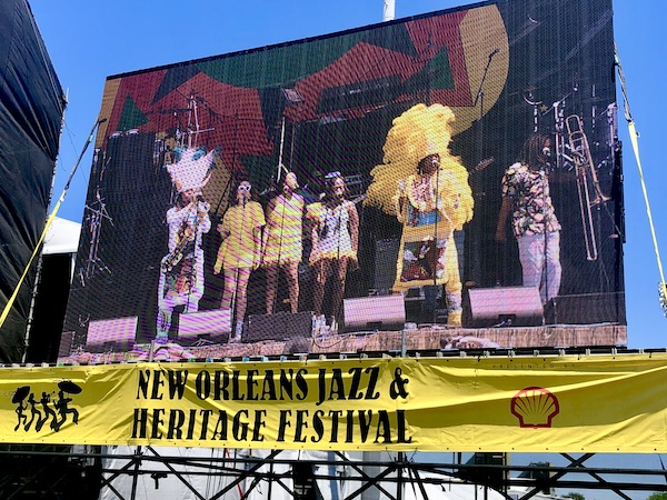 Mardi gras Indians perform viewed on a jumbotron at New Orleans Jazz and Heritage Festival