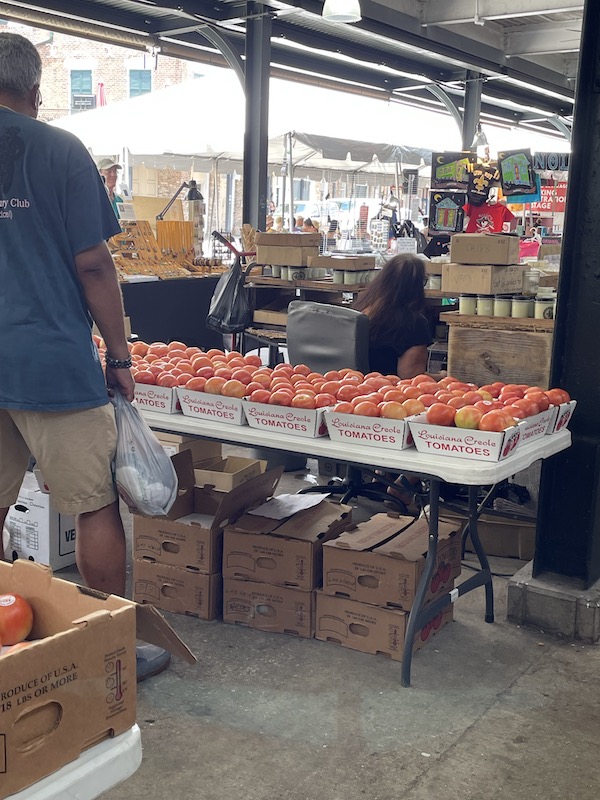 Table topped with small boxes of ripe tomatoes at the 37th Creole Tomato Festival NOLA