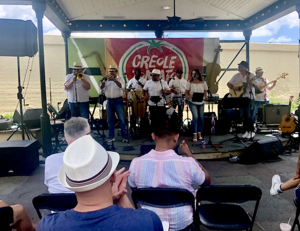 9 piece band playing on a stage at the 37th Creole Tomato Festival NOLA