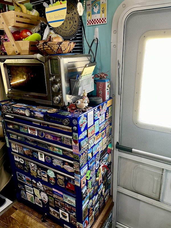 Blue mechanics' tool chest covered in souvenir magnets with oven on top where I make Air Fryer Garlic Ciabatta Bread