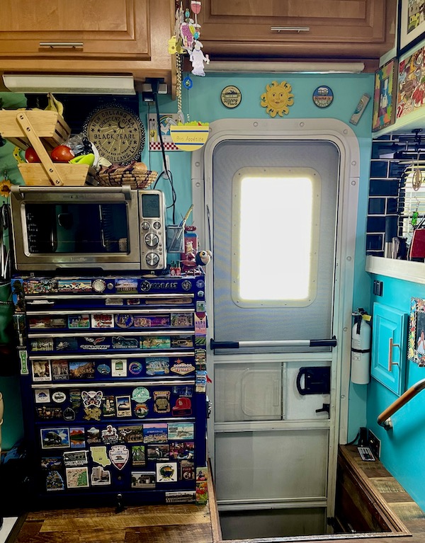 Blue mechanics' tool chest covered in souvenir magnets with oven on top where I make Air Fryer Garlic Ciabatta Bread
