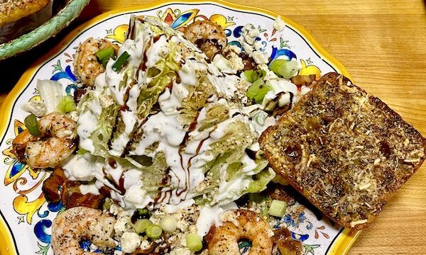 Plate of The Wedge Salad Cajun Style with shrimp and air fryer ciabatta garlic rolls.