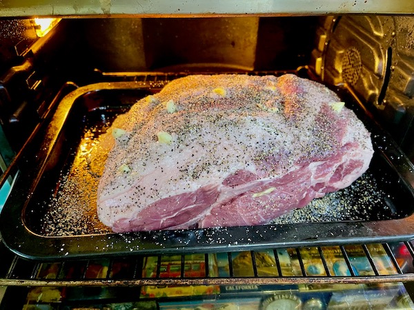 Easy Alabama Pulled Pork in the oven with lots of garlic popping out.