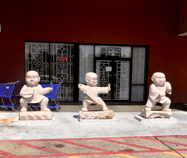 3 baby buddha statues in front of the Hong Kong Food Market