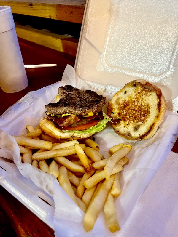Styro clamshell holding a burger and fries at our second stop from NOLA to Lake Worth Florida