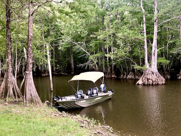 Boat in the Yellow River b the river bank at our first stop from NOLA to Lake Worth Florida