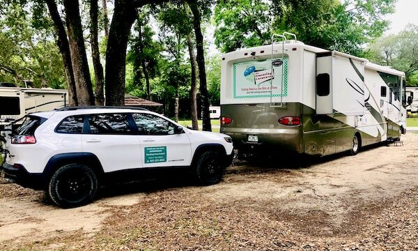 Our RV and car in our site at our first stop from NOLA to Lake Worth Florida