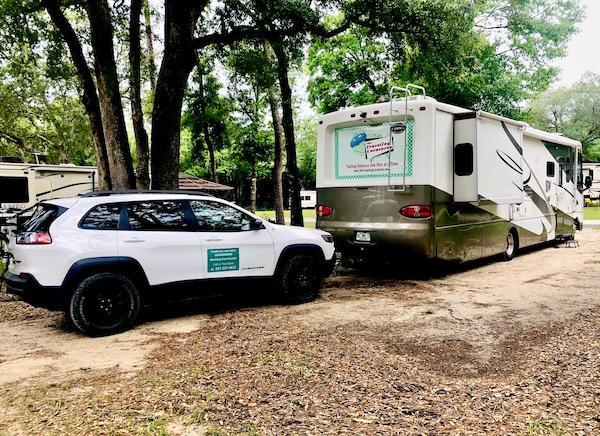 Our RV and car in our site at our first stop from NOLA to Lake Worth Florida