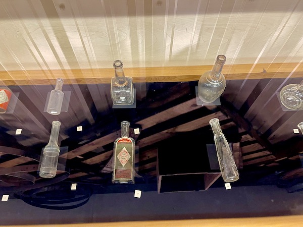 Display case with antique bottles that were used to hold Tabasco sauce