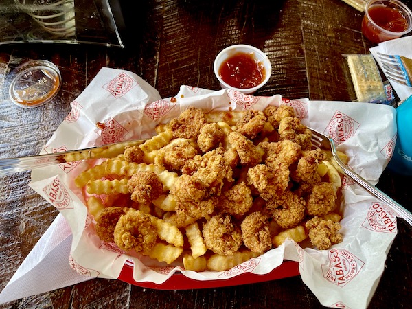 Basket of fried shrimp and potatoes with cocktail sauce during our Tabasco Avery Island Experience