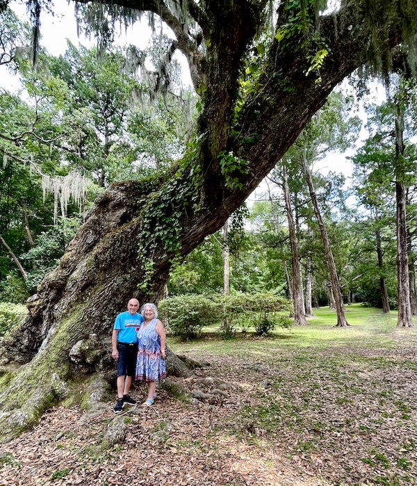 Us posing by a gnarled old oak tree during our Tabasco Avery Island Experience