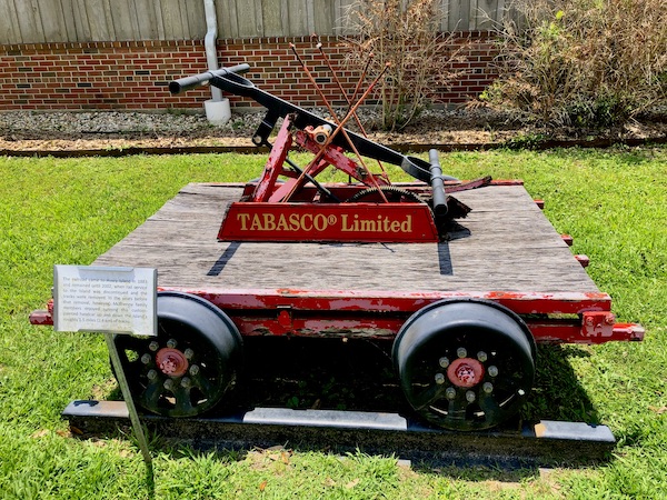 An antique railroad handcar with the Tabasco trademark.