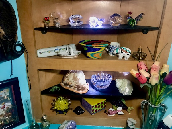 Corner shelves displaying art for a way to make our RV feel like home.