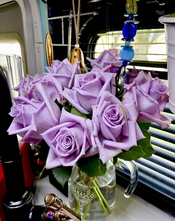 Lavender colored roses in a glass vase show How to Make Your RV Feel Like Home