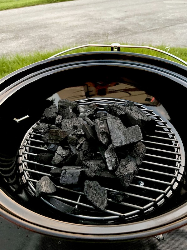 Grill grate of Weber Jumbo Joe Charcoal Grill with a pyramid of charcoal