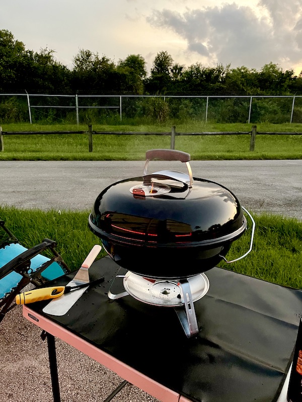Flames coming out of the top vents of our Weber Jumbo Joe Charcoal Grill