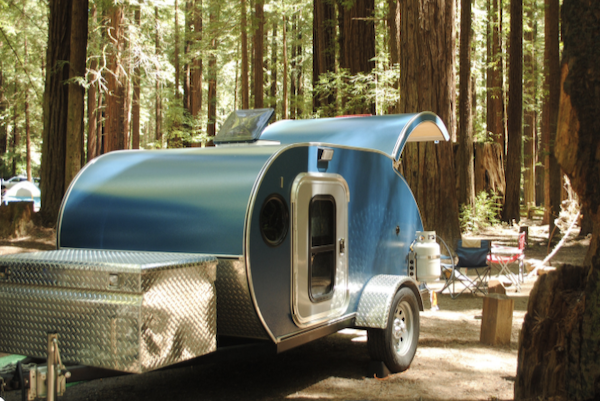 Turquoise and white teardrop travel trailer is and example of What Type of RV is Best for You?